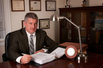 Covington attorney Paul J. Dickman sitting at a desk