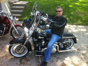 Attorney Paul J. Dickman from Dickman Law Office P.S.C. riding a motorcycle