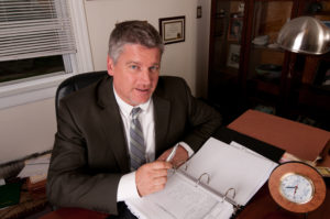 Attorney Paul J. Dickman at his desk at the Dickman Law Office
