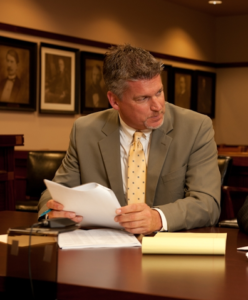 Attorney Paul J. Dickman discussing with clients in court
