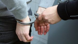 A youth being handcuffed