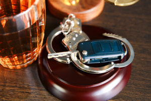 Car keys and drink, symbolizing a DUI.