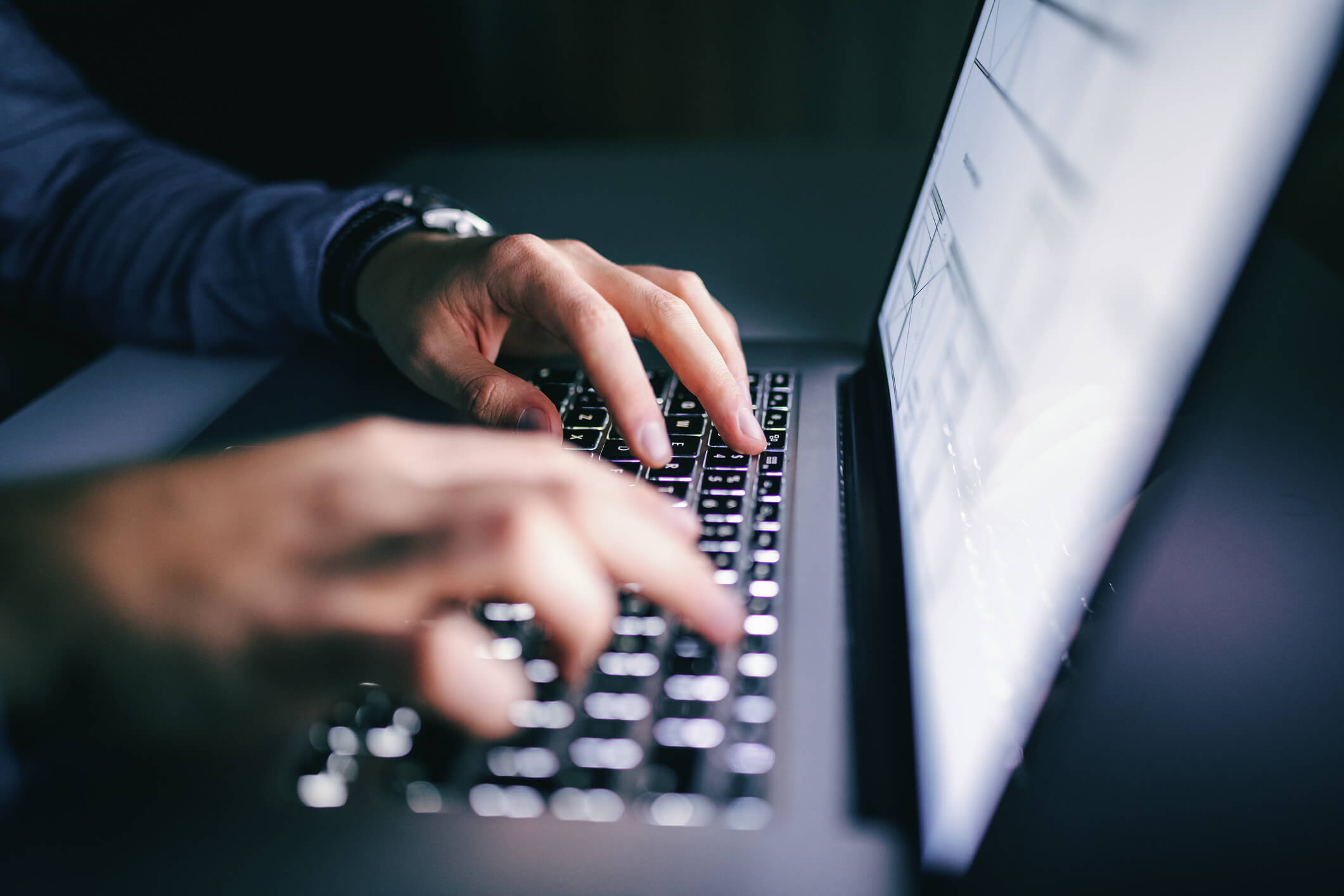 Man on his computer committing a crime