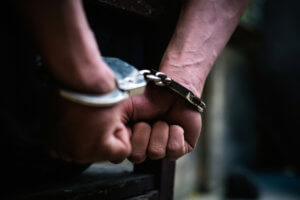 Man with handcuffs on, arrested.
