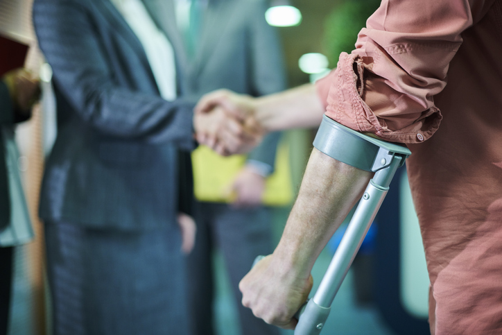 Injured client shaking hands with lawyer