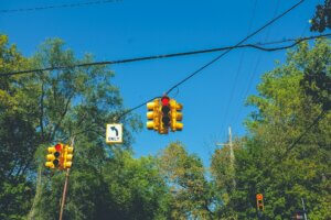 Red lights at a tree-lined intersection
